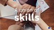 Viele aufeinanderliegende Hände und in der Mitte der Schriftzug "A union of skills"